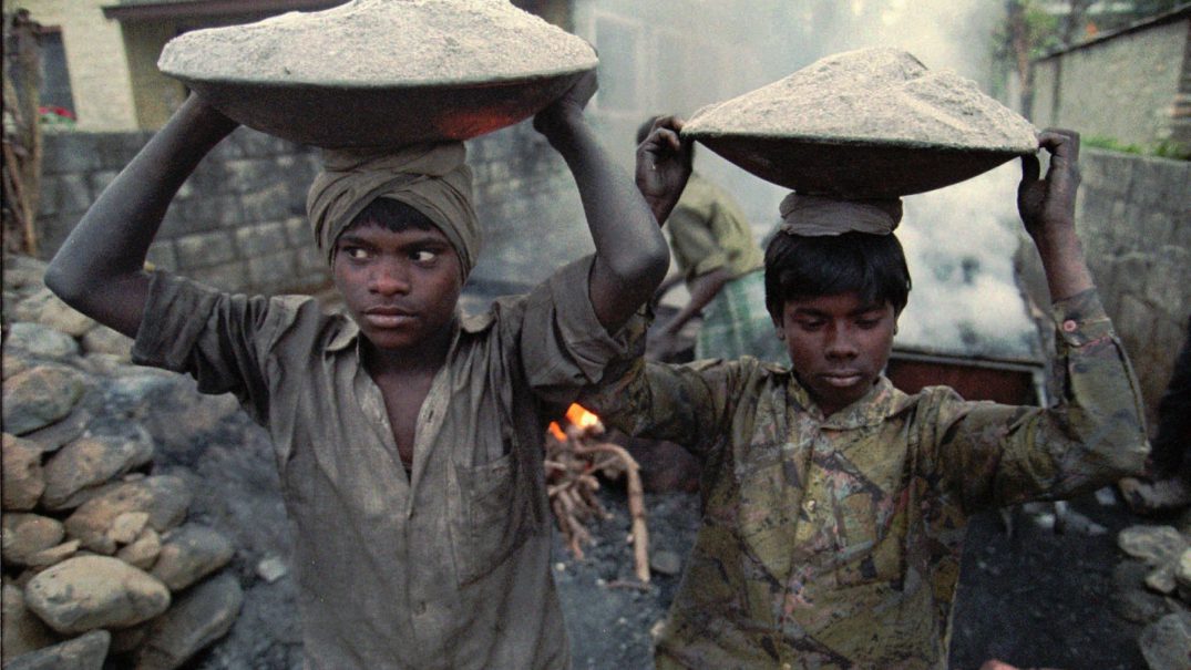 Child laborers carry fine gravel to make asphalt while constructing "tourist roads" in Pokhara, Nepal Dec. 26, 1996. They work for up to 16 hours a day and earn less than $1. According to UNICEF reports, children are used because they are easier to handle, often working in extremely hazardous conditions without questioning authority.