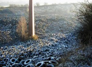 Hundreds of fly-tipped tyres in a disused chalk quarry in Kent. Photo: Wikimedia Commons.